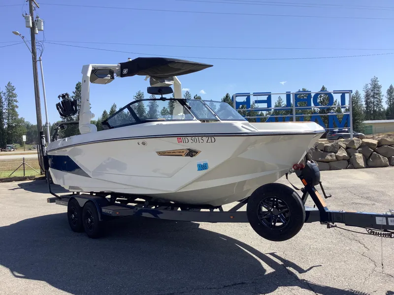 Slide: The Image of 2024 Nautique Super Air G23 boat on trailer in outdoor setting. - 7