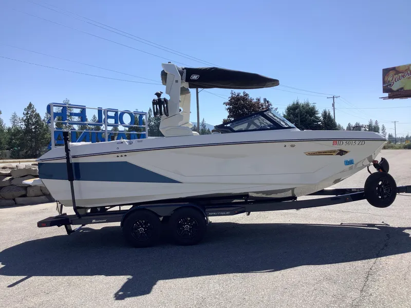Slide: The Image of 2024 Nautique Super Air G23 boat on trailer, parked outdoors. - 9