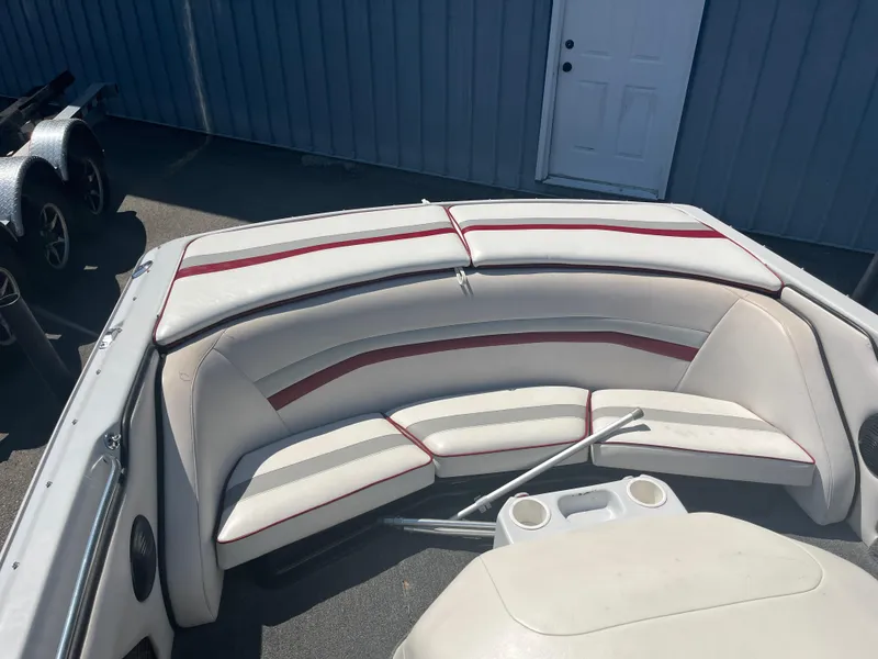 Slide: The Image of 1999 Sanger Ski Sanger boat interior with white and red seating, cup holders, and storage. - 13