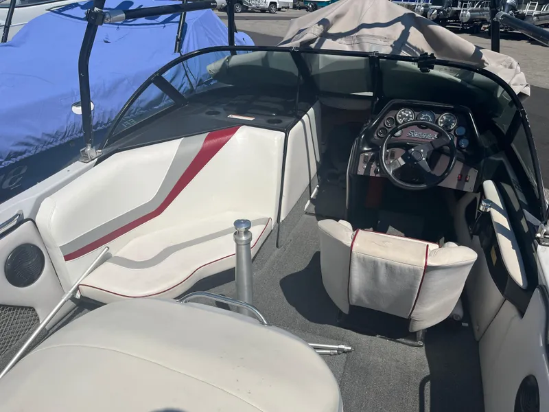 Slide: The Image of 1999 Sanger Ski Sanger boat interior with steering wheel and seating. - 8