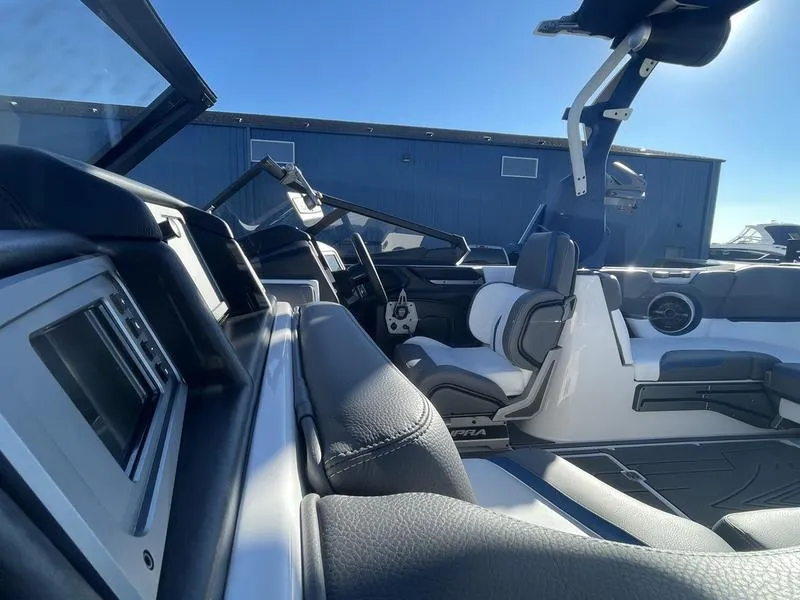 Slide: The Image of 2023 Supra SA 450 boat interior with sleek black and white seating. - 11