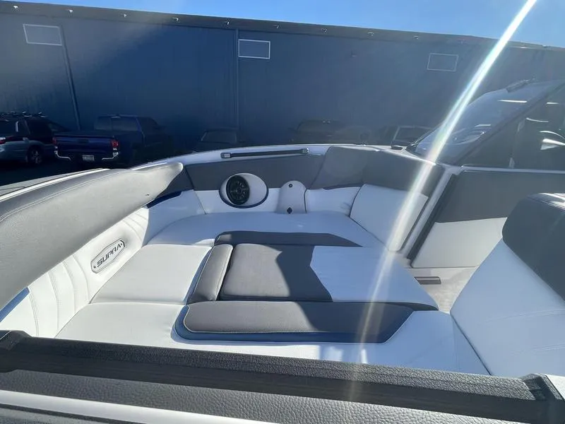 Slide: The Image of 2023 Supra SA 450 boat interior with sleek seating and speaker system. - 13