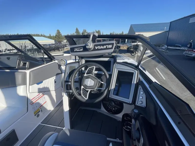 Slide: The Image of 2023 Supra SA 450 boat cockpit with modern steering and digital displays. - 16