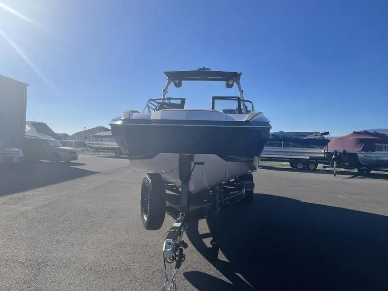 Slide: The Image of 2023 Supra SA 450 boat on trailer under clear blue sky. - 3