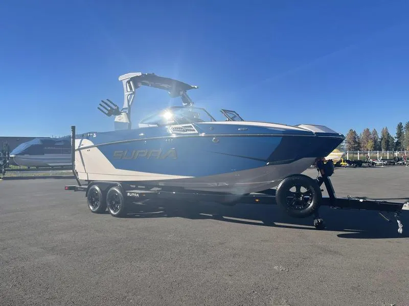 Slide: The Image of 2023 Supra SA 450 boat on trailer under clear blue sky. - 4