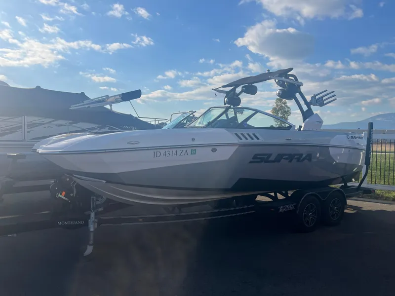 Slide: The Image of 2017 Supra SA 450 boat on trailer under blue sky. - 11