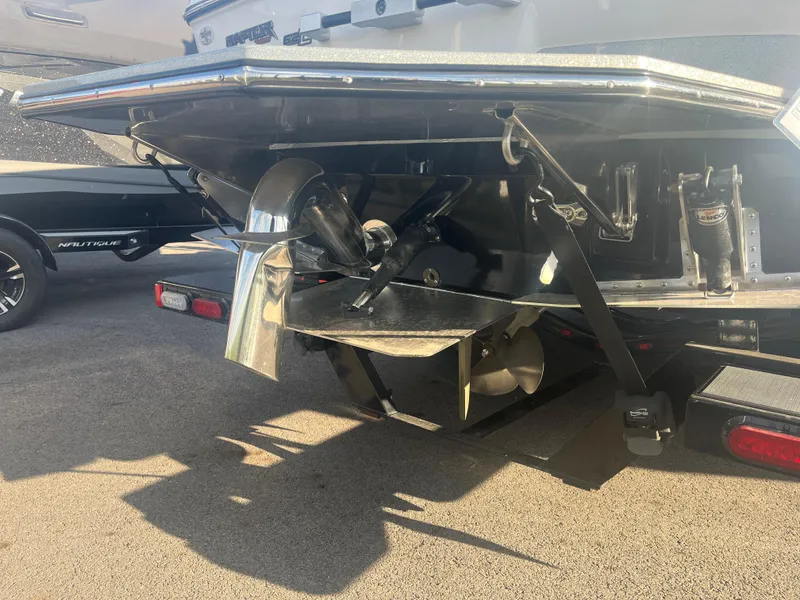 Slide: The Image of Rear view of a 2017 Supra SA 450 boat, showcasing propeller and trim tabs. - 14