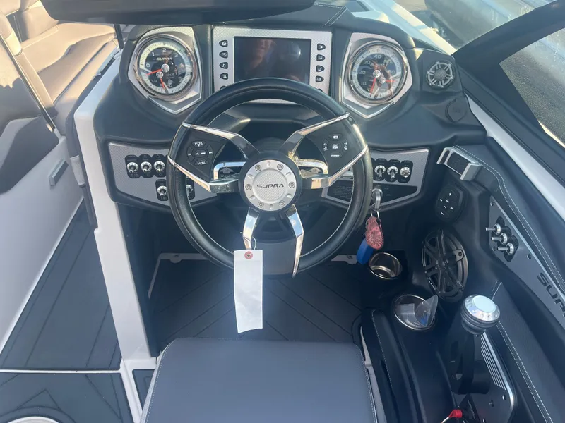 Slide: The Image of 2017 Supra SA 450 boat dashboard with steering wheel and control panel. - 20