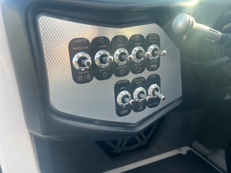 Slide: The Image of Control panel of a 2017 Supra SA 450 boat with various switches. - 22
