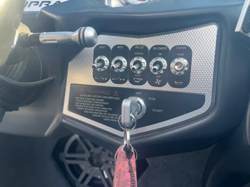 Slide: The Image of Control panel of a 2017 Supra SA 450 boat with ignition key and switches. - 23