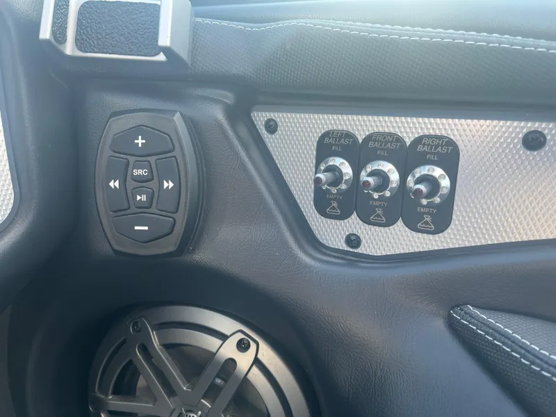 Slide: The Image of Control panel of 2017 Supra SA 450 boat with ballast switches and audio controls. - 24