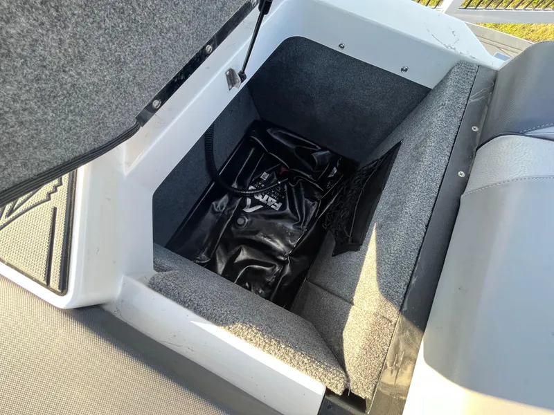 Slide: The Image of 2017 Supra SA 450 boat storage compartment with black bag inside. - 29