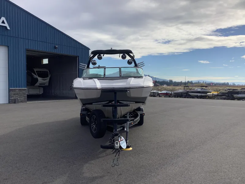 Slide: The Image of 2017 Supra SA 450 boat on trailer outside blue warehouse. - 3