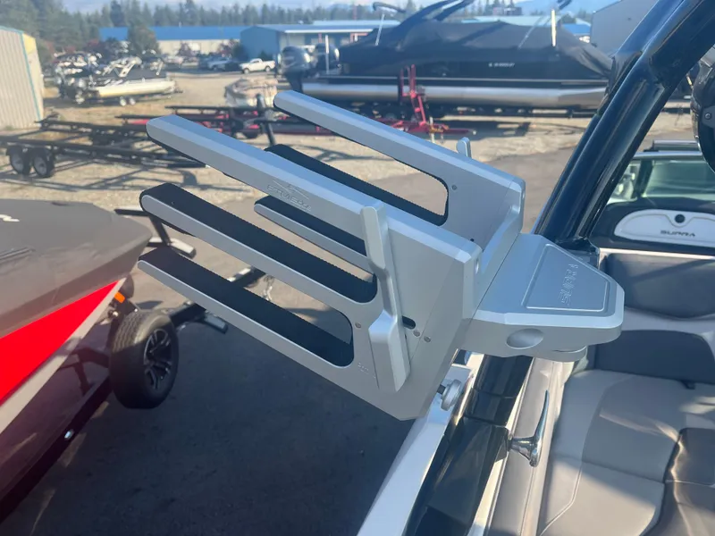 Slide: The Image of 2017 Supra SA 450 boat with a wakeboard rack in a marina setting. - 31