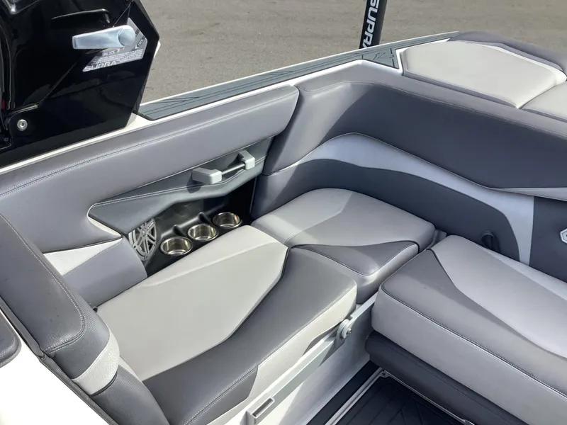 Slide: The Image of 2017 Supra SA 450 boat interior with gray seating and cup holders. - 38
