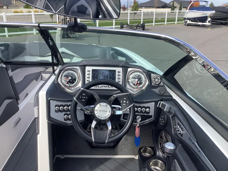 Slide: The Image of 2017 Supra SA 450 boat dashboard with steering wheel and control panel. - 40