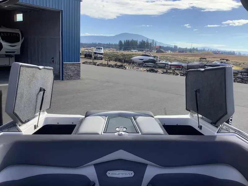 Slide: The Image of 2017 Supra SA 450 boat with open storage compartments in a marina setting. - 49