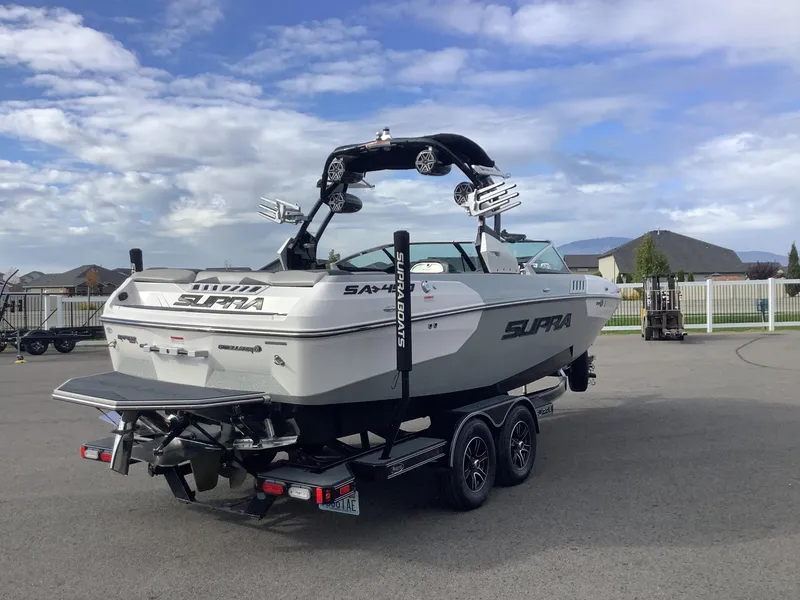 Slide: The Image of 2017 Supra SA 450 boat on trailer, parked outdoors under a cloudy sky. - 6