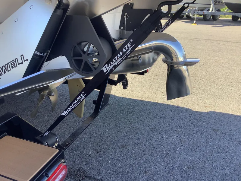 Slide: The Image of 2023 Supra SE 550 boat trailer with Boatmate branding, featuring a polished exhaust system. - 11