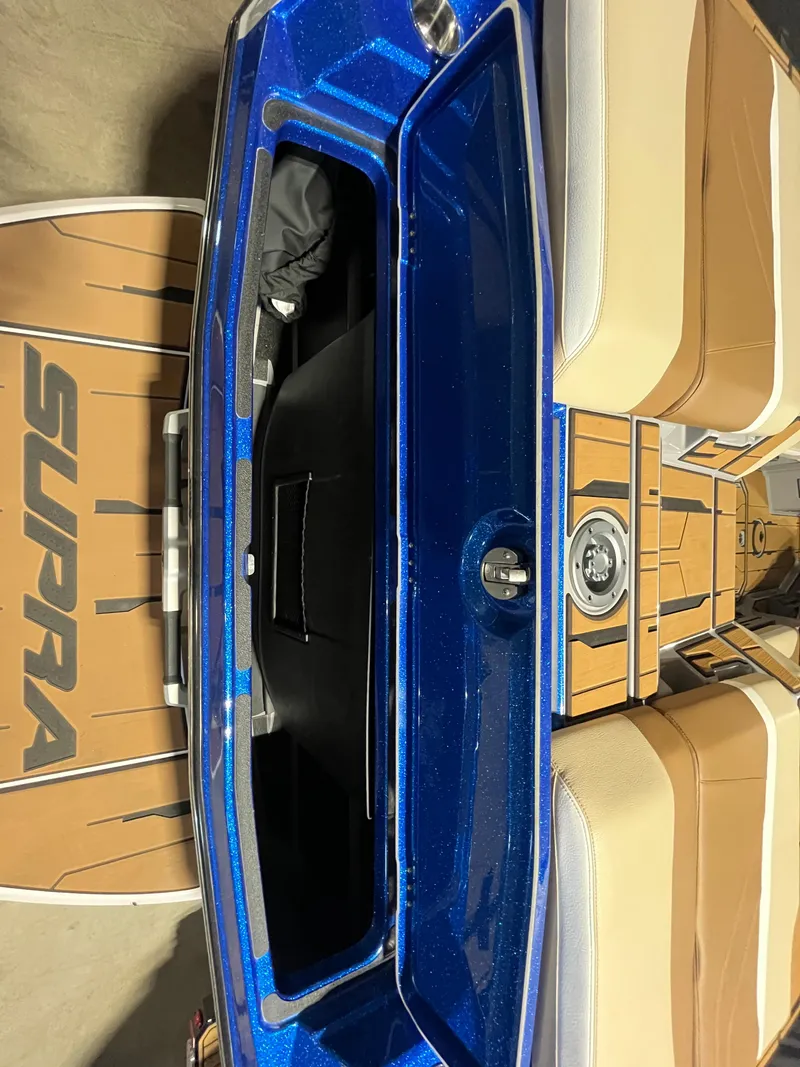 Slide: The Image of 2023 Supra SE 550 boat interior with blue and tan design. - 13