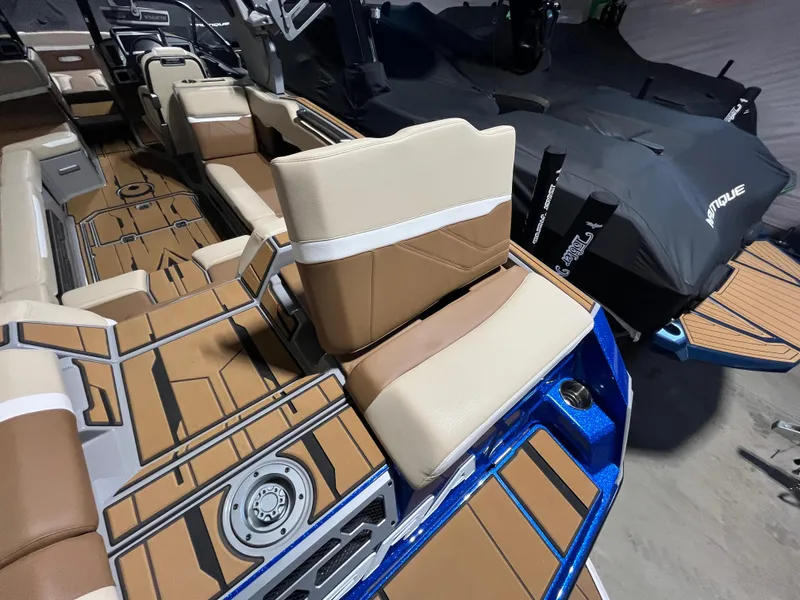 Slide: The Image of 2023 Supra SE 550 boat interior with tan and brown seating, modern design. - 14