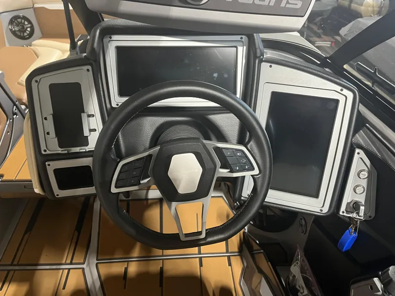 Slide: The Image of 2023 Supra SE 550 boat dashboard with modern steering wheel and digital displays. - 15