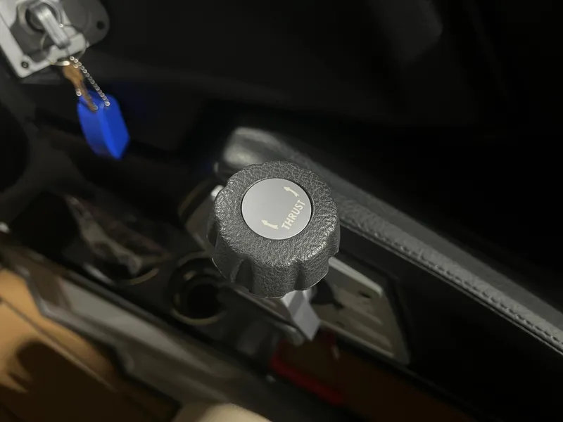 Slide: The Image of 2023 Supra SE 550 throttle control with key and blue keychain. - 17
