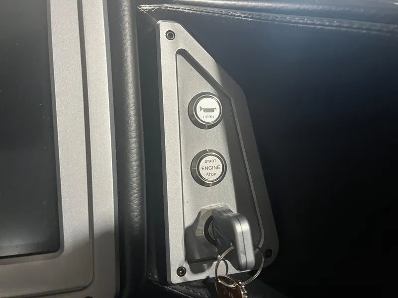 Slide: The Image of 2023 Supra SE 550 dashboard with horn and engine start buttons. - 18