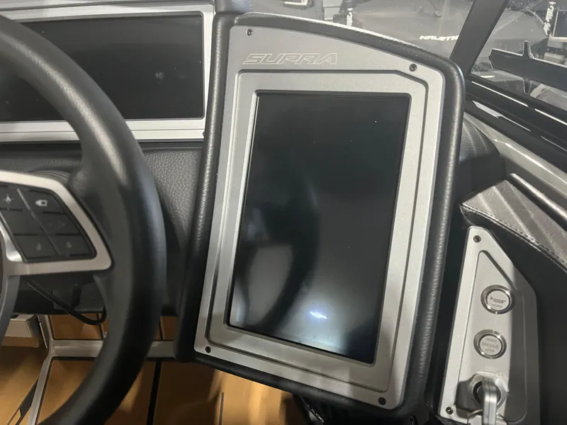 Slide: The Image of 2023 Supra SE 550 dashboard with touchscreen and steering wheel controls. - 19