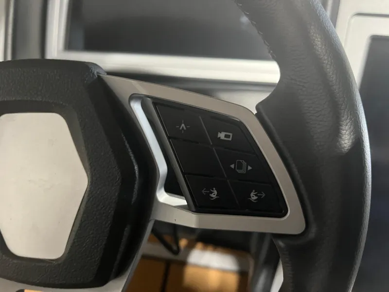 Slide: The Image of Close-up of 2023 Supra SE 550 steering wheel controls. - 22
