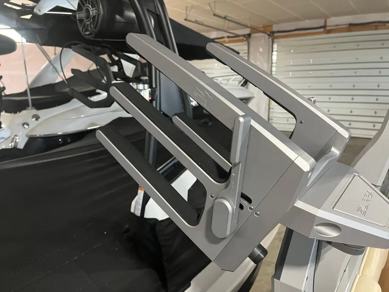 Slide: The Image of 2023 Supra SE 550 boat with wakeboard rack in a garage setting. - 27
