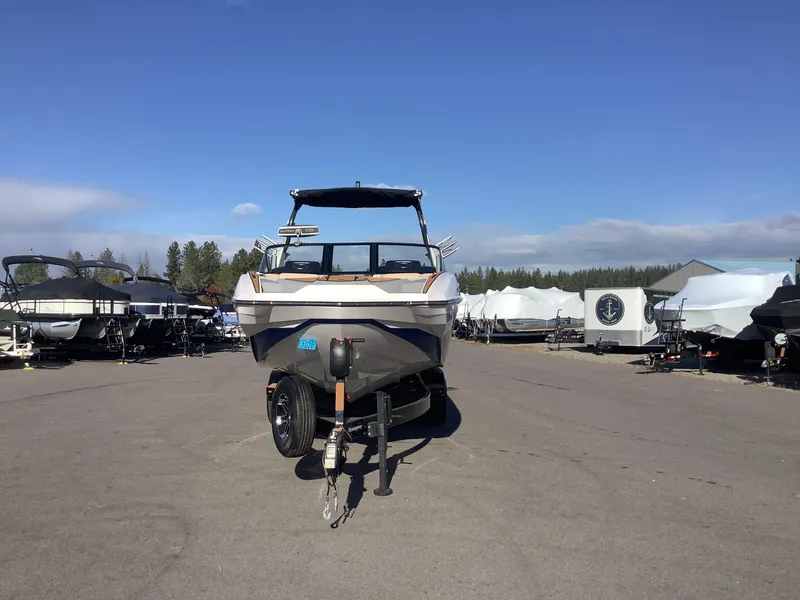 Slide: The Image of 2023 Supra SE 550 boat on trailer in outdoor storage lot. - 3