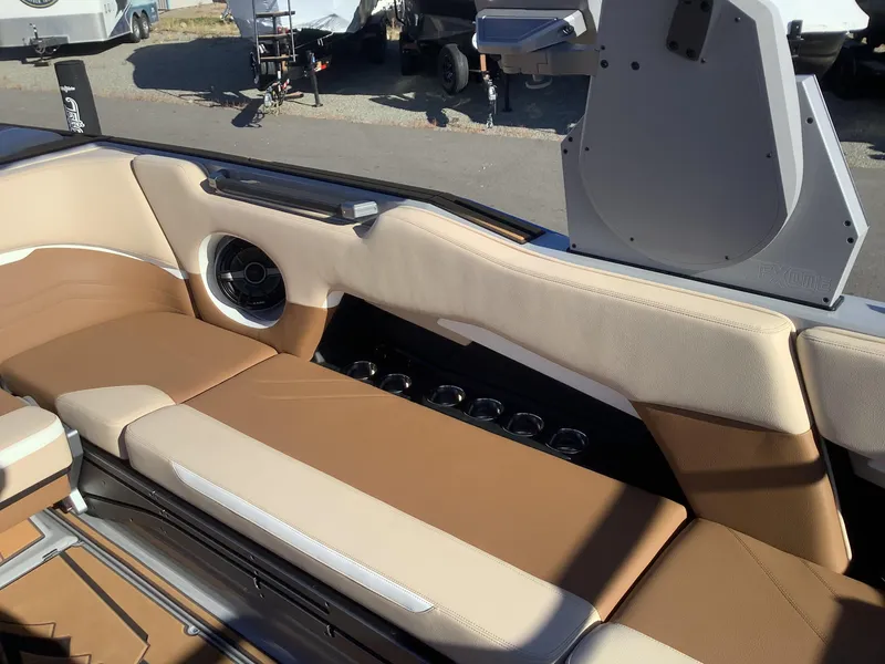 Slide: The Image of 2023 Supra SE 550 boat interior with tan leather seating and built-in speaker system. - 30