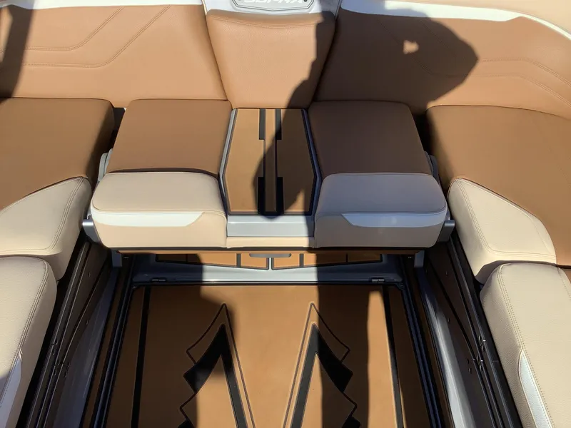 Slide: The Image of 2023 Supra SE 550 boat interior with tan and beige seating. - 36