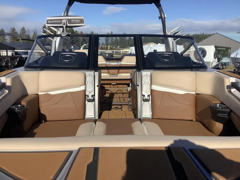 Slide: The Image of 2023 Supra SE 550 boat interior with tan and brown seating, open-air design. - 4