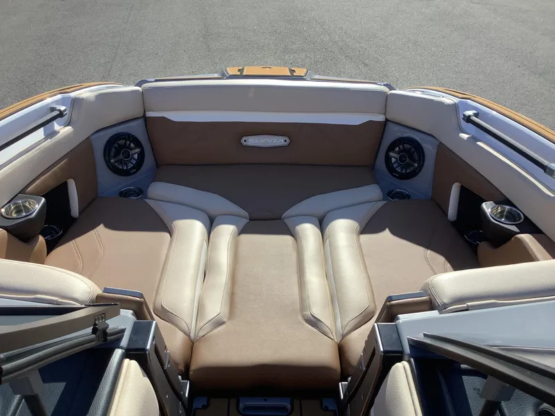 Slide: The Image of 2023 Supra SE 550 boat interior with beige seating and built-in speakers. - 40