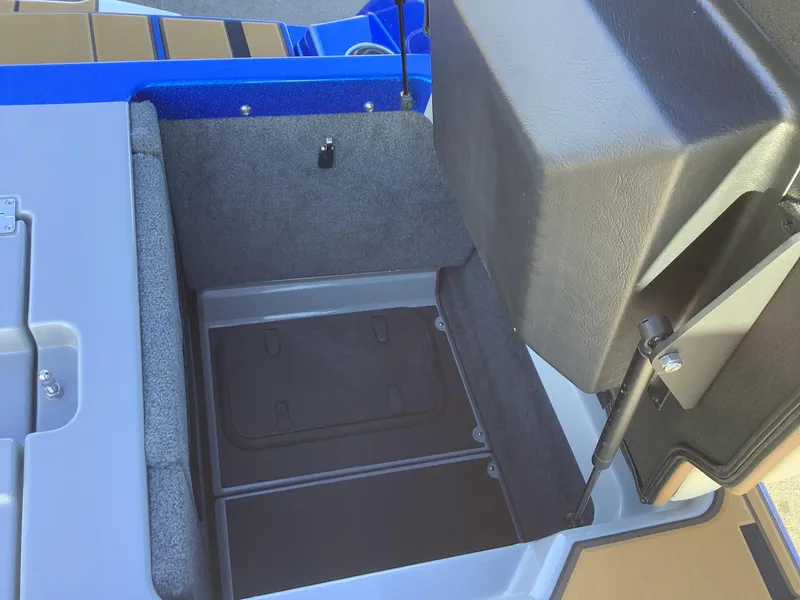 Slide: The Image of 2023 Supra SE 550 boat storage compartment with open lid, showcasing interior space. - 44