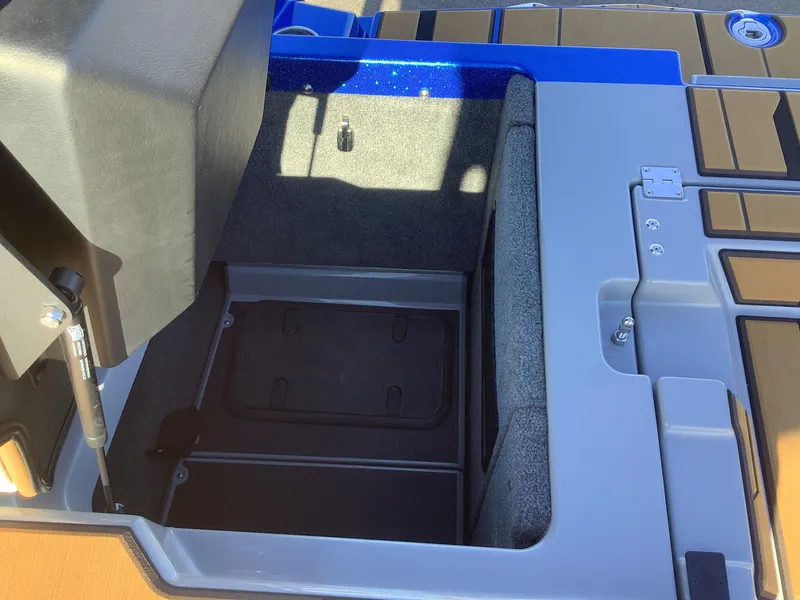 Slide: The Image of 2023 Supra SE 550 boat storage compartment with open lid. - 45