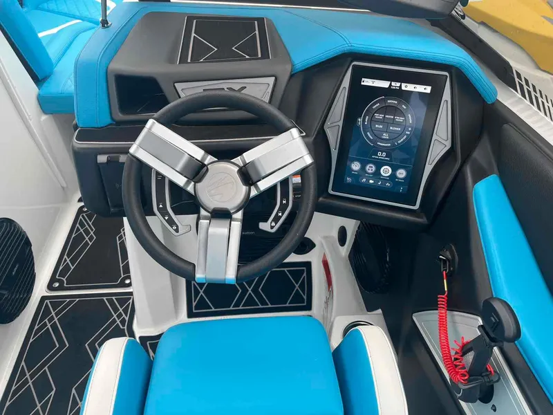 Slide: The Image of 2023 Tigé 25ZX boat cockpit with modern steering wheel and touchscreen controls. - 10