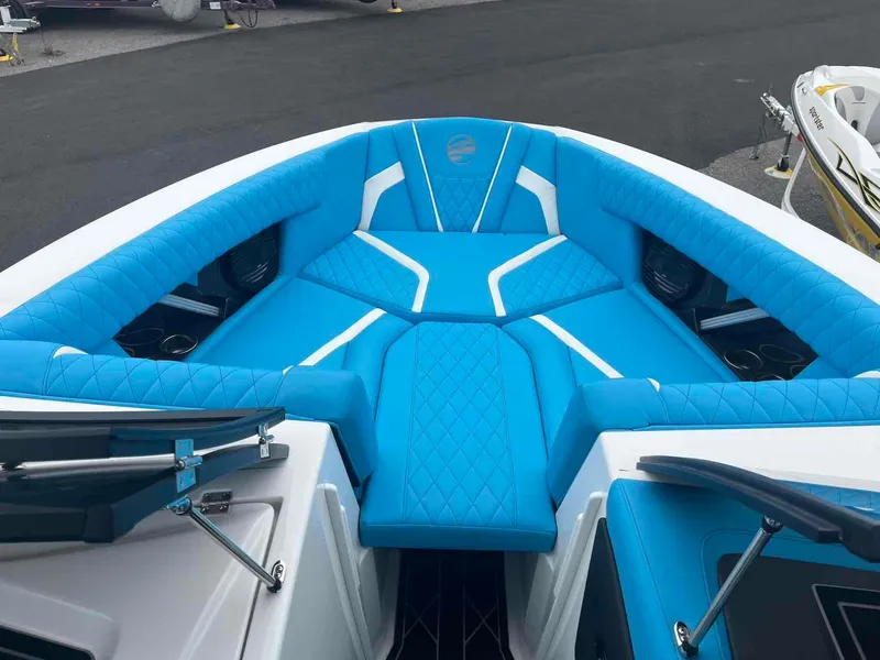 Slide: The Image of 2023 Tigé 25ZX boat with vibrant blue seating and modern design. - 12