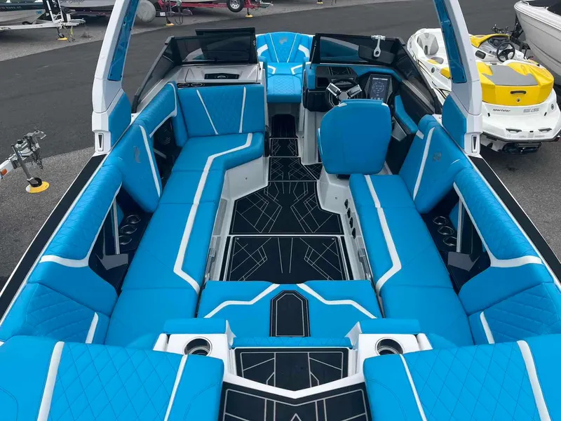 Slide: The Image of 2023 Tigé 25ZX boat interior with blue seating and modern dashboard. - 14