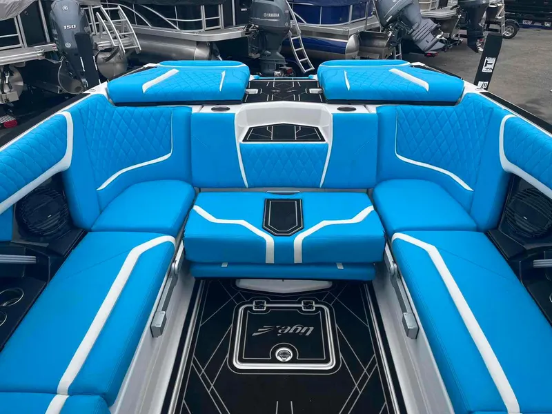 Slide: The Image of 2023 Tigé 25ZX boat interior with vibrant blue seating and modern design. - 15