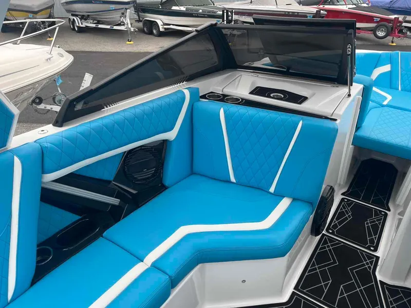 Slide: The Image of 2023 Tigé 25ZX boat interior with blue and white seating, modern design. - 16