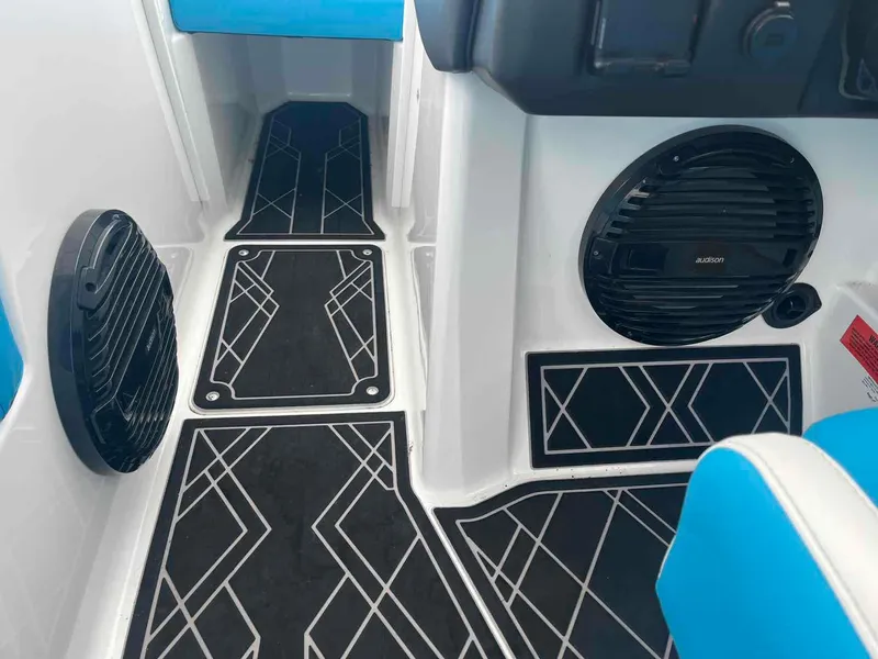 Slide: The Image of 2023 Tigé 25ZX boat interior with stylish black flooring and audio speakers. - 7