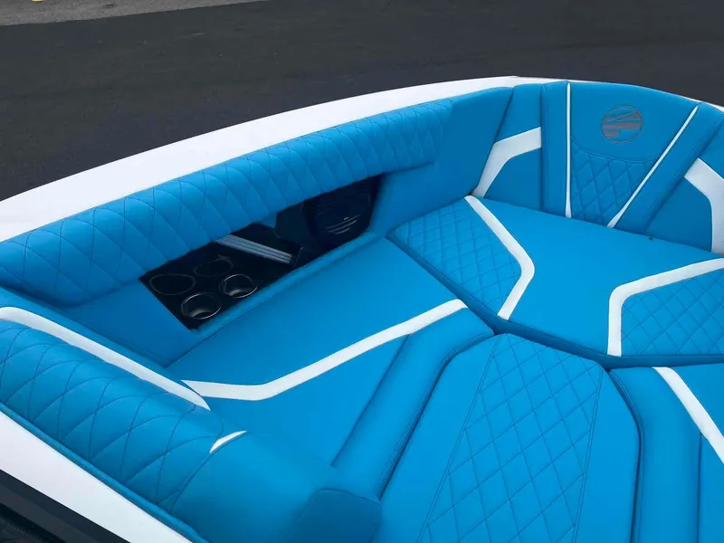 Slide: The Image of 2023 Tigé 25ZX boat interior with blue and white cushioned seating. - 9