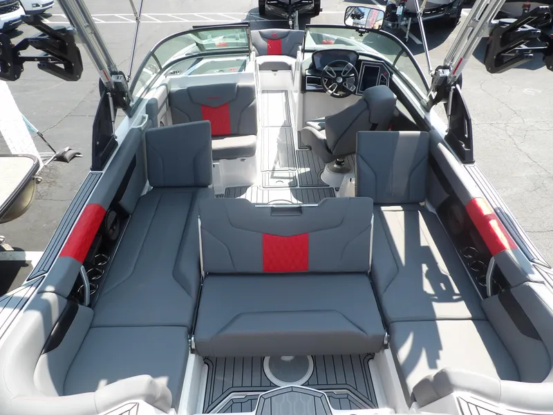 Slide: The Image of 2024 MasterCraft XT25 boat interior with gray and red seating. - 12