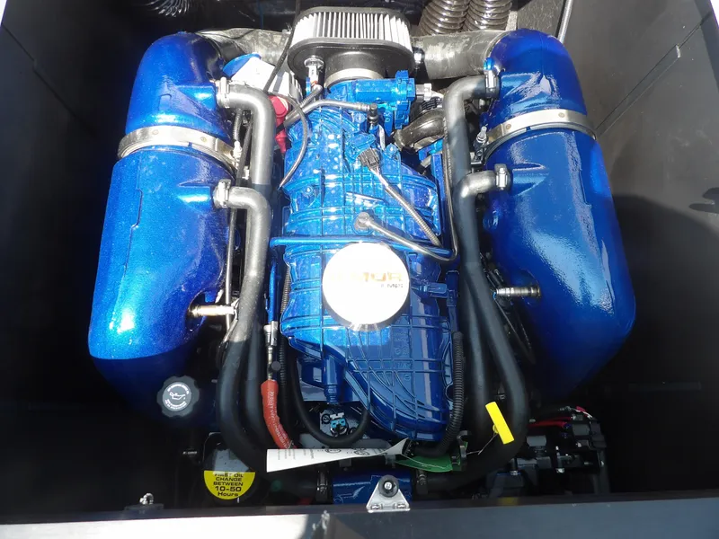 Slide: The Image of 2024 MasterCraft XT25 engine with vibrant blue components. - 13