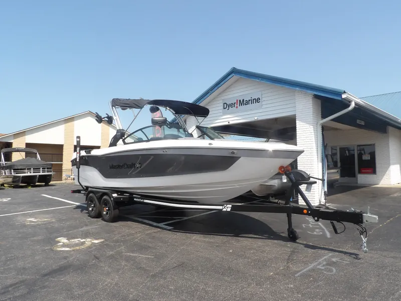 Slide: The Image of 2024 MasterCraft XT25 boat on trailer at Dyer Marine dealership. - 3