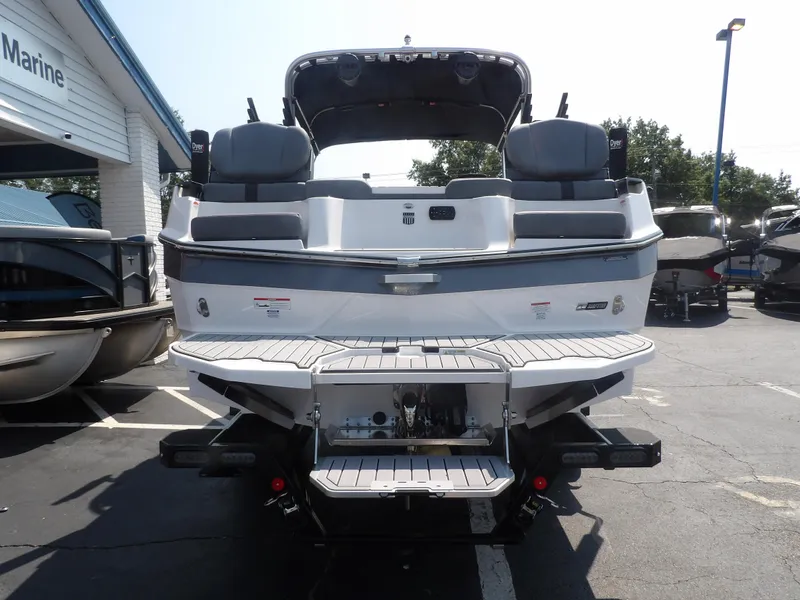 Slide: The Image of 2024 MasterCraft XT25 boat rear view in a marina parking lot. - 5