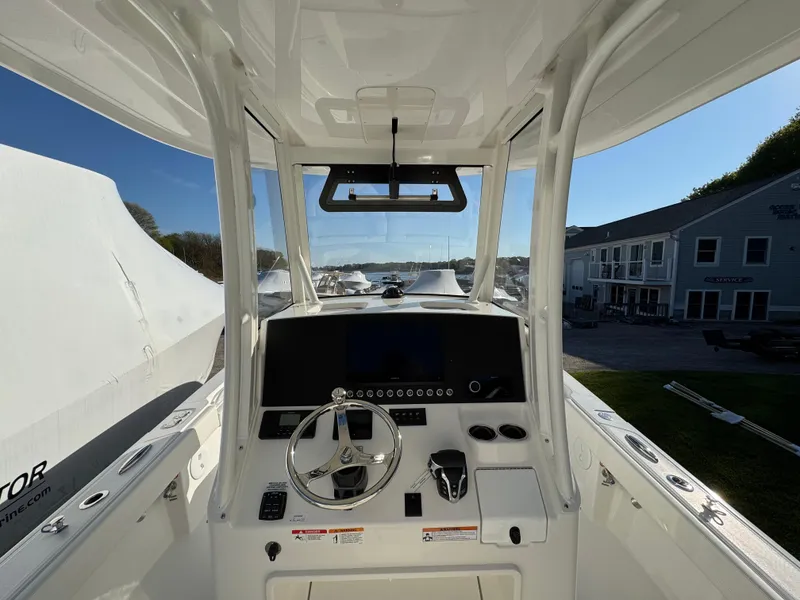 Slide: The Image of 2025 Regulator 26XO boat cockpit with steering wheel and control panel. - 10